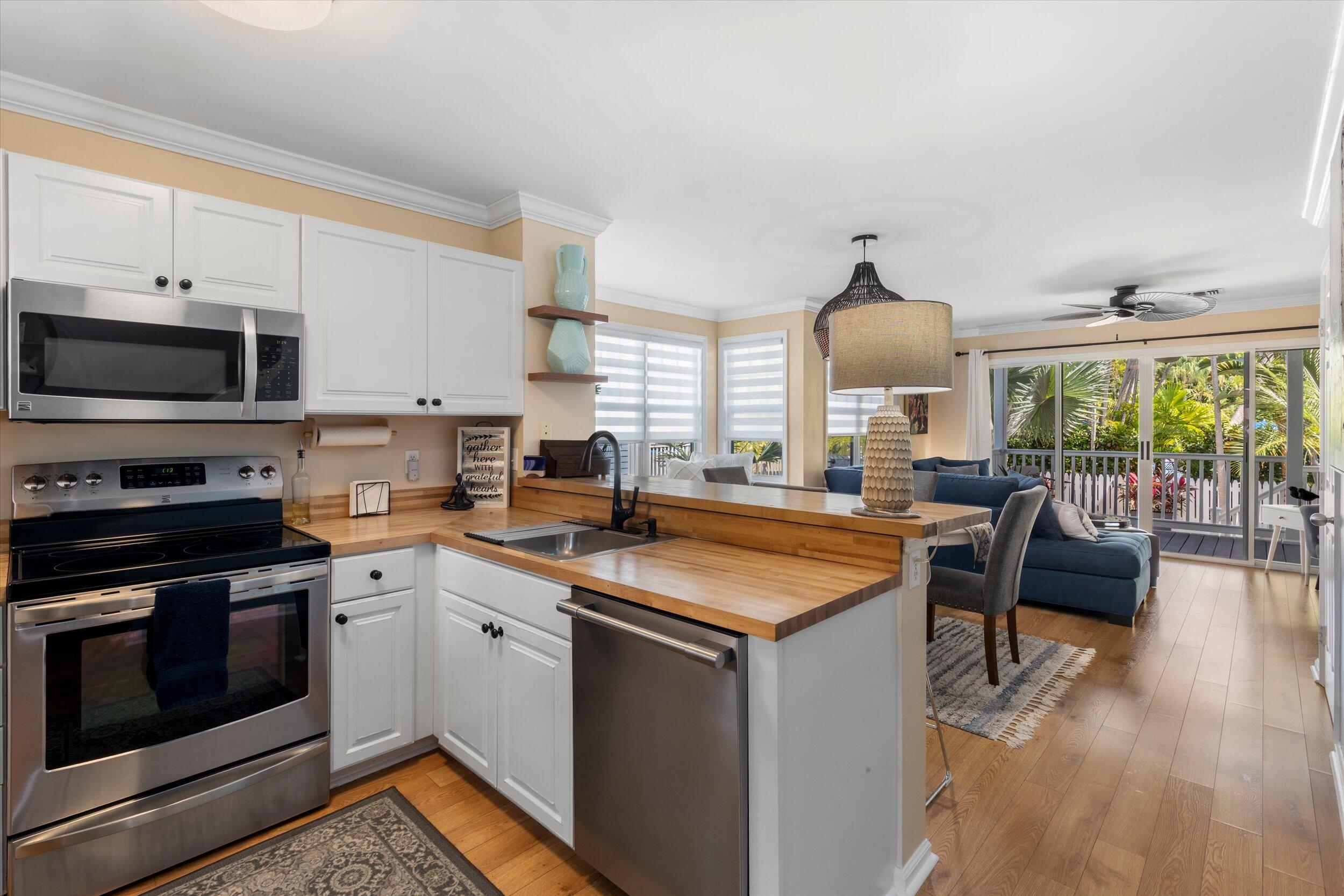 37 Spoonbill Way Key West, FL 33040 - Photo 6 of 88 a kitchen with stainless steel appliances granite countertop a stove a sink and a microwave