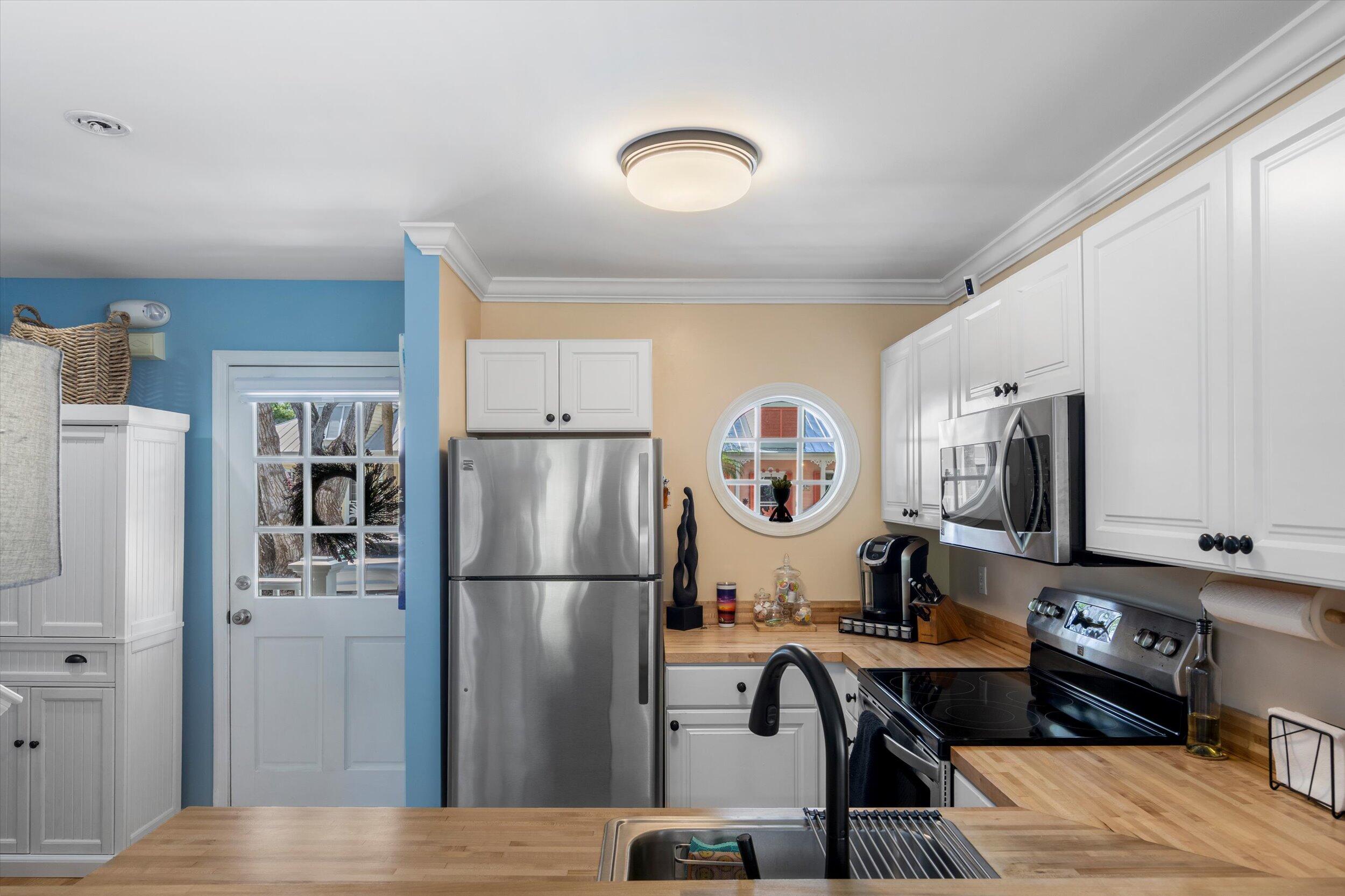 37 Spoonbill Way Key West, FL 33040 - Photo 10 of 88 a kitchen with stainless steel appliances granite countertop a refrigerator a stove a sink and a microwave