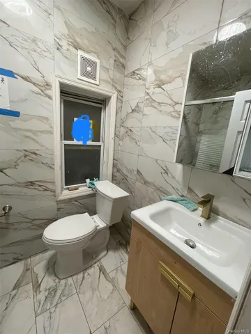 a bathroom with a sink toilet and mirror