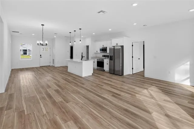 a view of a kitchen with wooden floor