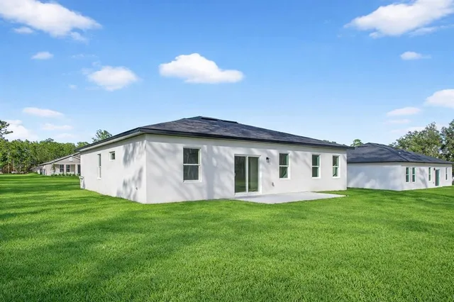 a view of a house with a backyard