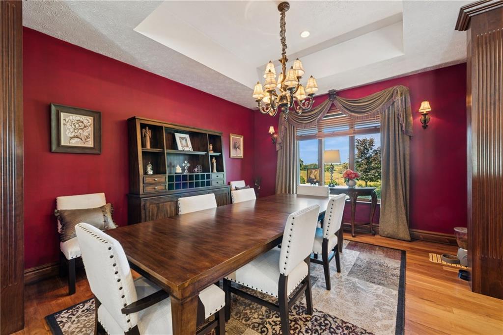 577 Bovard Luxor Road Luxor, PA 15662 - Photo 12 of 42 a view of a dining room with furniture a chandelier and wooden floor