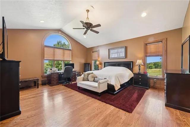 a spacious bedroom with a large bed and a window