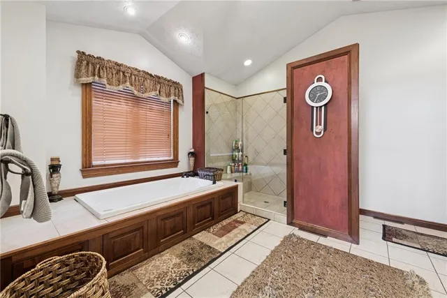 a spacious bathroom with a double vanity sink a mirror and a bathtub