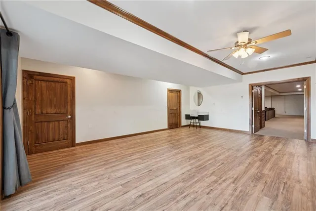a view of an empty room and wooden floor