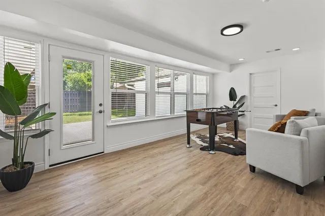 a living room with furniture and a flat screen tv with wooden floor