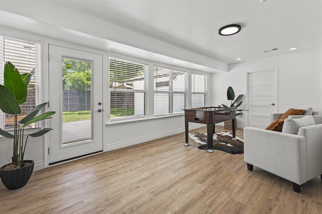 4105 Candlenut Lane Dallas, TX 75244 - Photo 11 of 27 a living room with furniture and a flat screen tv with wooden floor