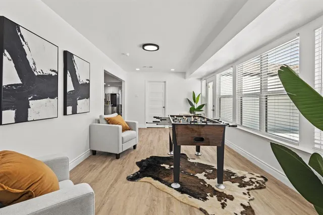 a living room with furniture and wooden floor