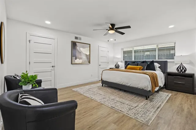 a bedroom with a bed and ceiling fan