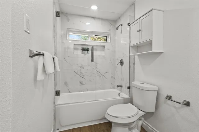 a bathroom with a toilet and a shower