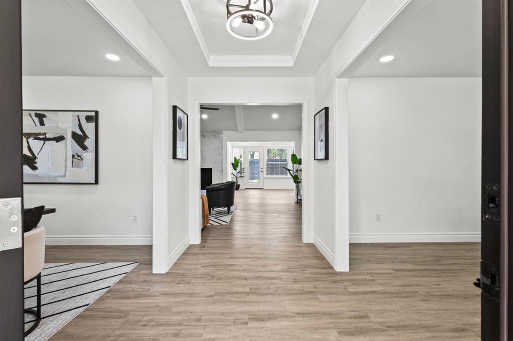 4105 Candlenut Lane Dallas, TX 75244 - Photo 2 of 27 wooden floor in a hall with an entryway