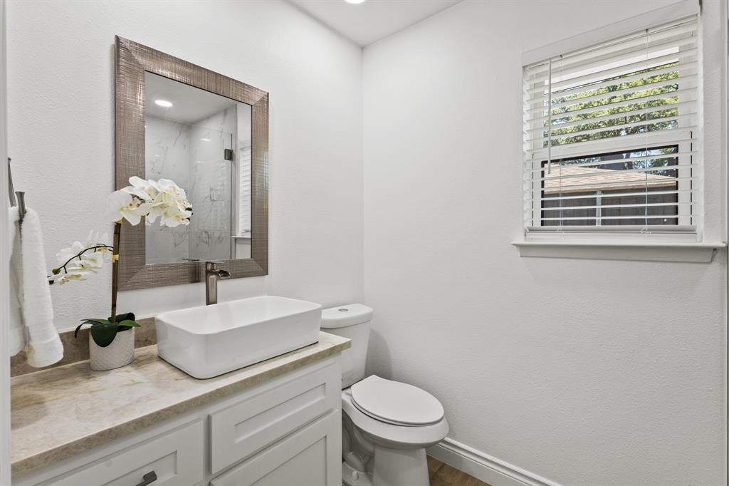 4105 Candlenut Lane Dallas, TX 75244 - Photo 21 of 27 a bathroom with a granite countertop sink mirror and toilet