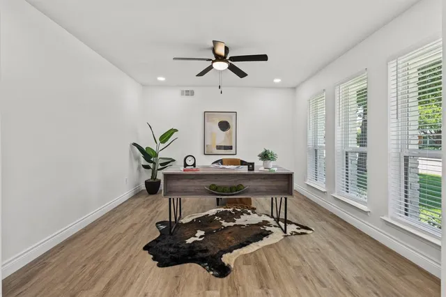 a view of a workspace with furniture and a window