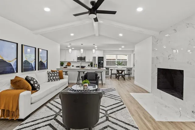 a living room with furniture kitchen and a fireplace