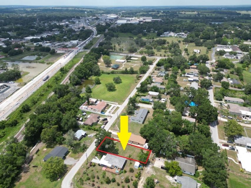 14306 1st Street Dade City, FL 33525 - Photo 8 of 9 an aerial view of residential houses with outdoor space and lake view