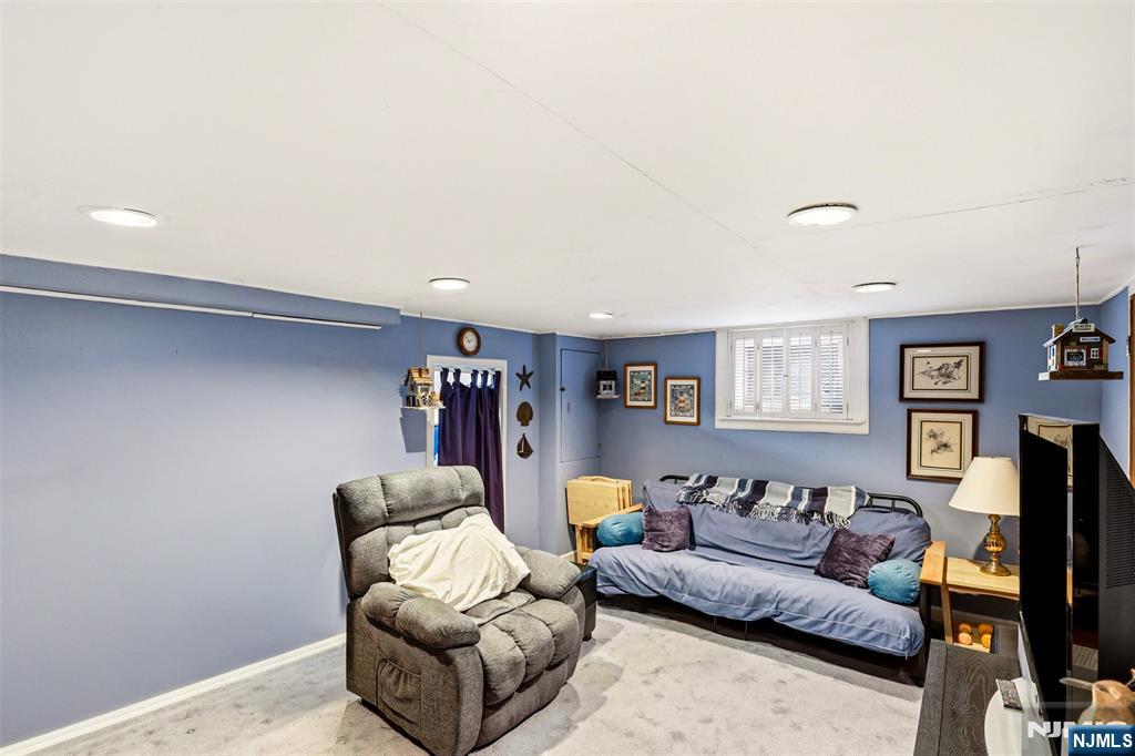332 Riverside Avenue Lyndhurst, NJ 07071 - Photo 26 of 31 a living room with furniture and a flat screen tv
