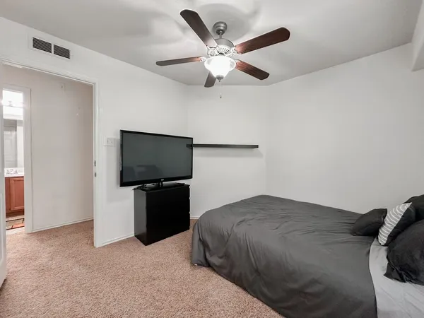 a bedroom with a bed and a flat screen tv