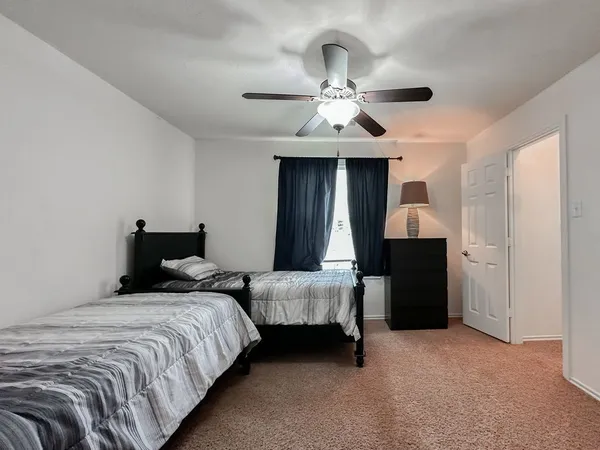 a bedroom with bed and a chandelier