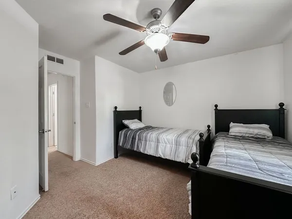 a bedroom with double bed and a chandelier