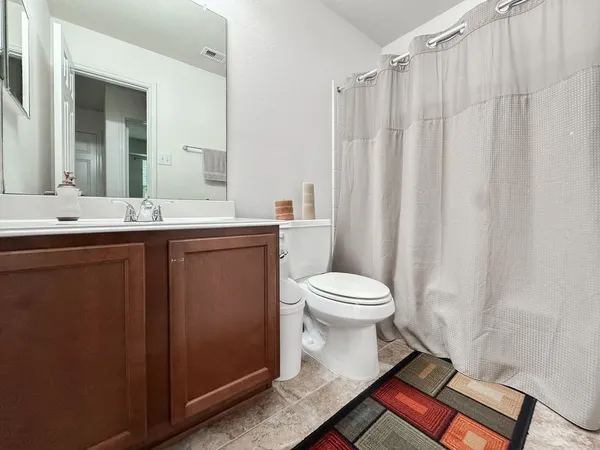 a bathroom with a toilet sink and shower