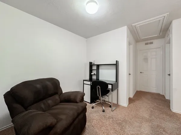 a livingroom with workspace and a couch