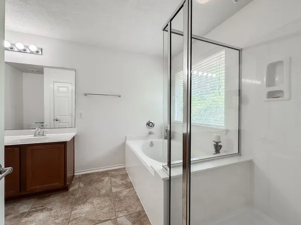 a bathroom with a bathtub and a sink