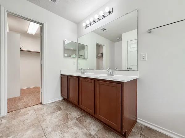 a bathroom with a double vanity sink and mirror