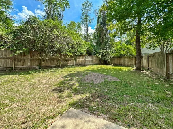a swimming pool with outdoor seating and yard