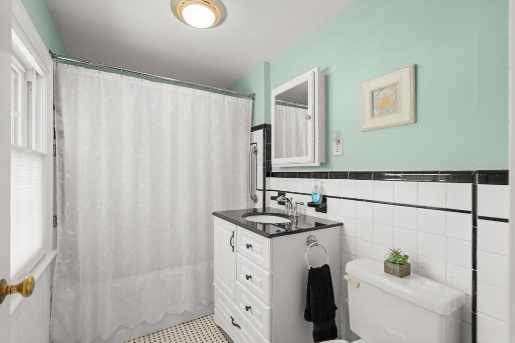 16 Bailey Lane Dedham, MA 02026 - Photo 21 of 40 a bathroom with a sink a toilet and a mirror