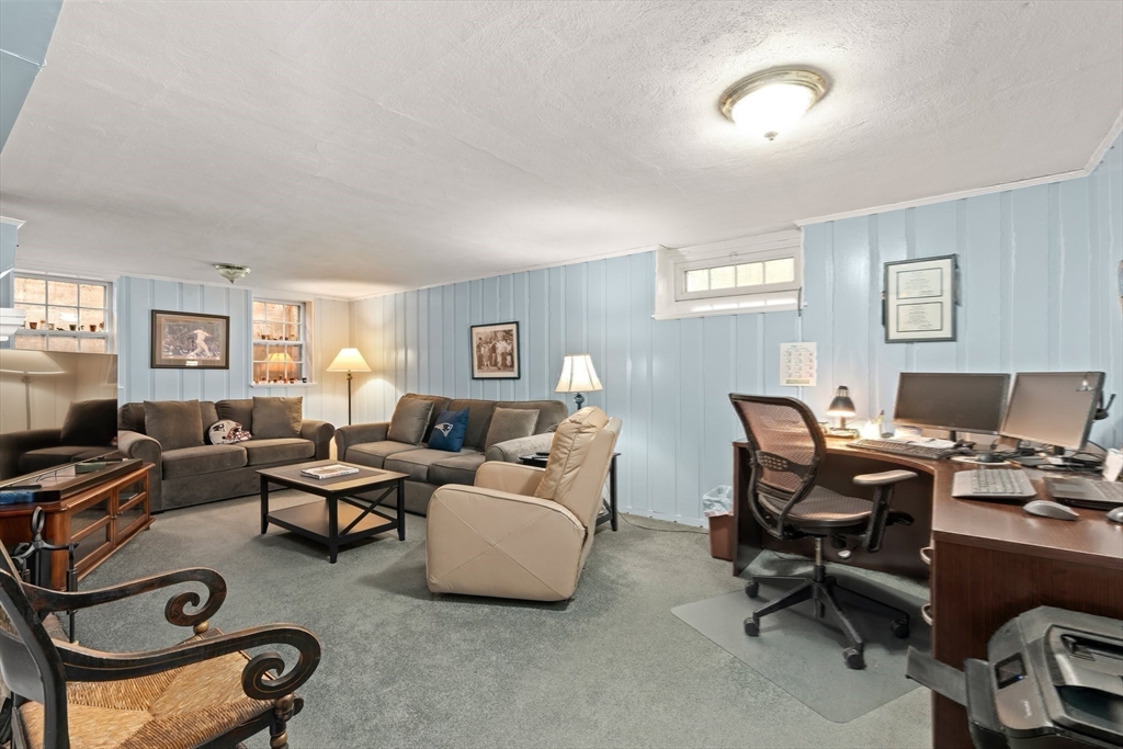 16 Bailey Lane Dedham, MA 02026 - Photo 27 of 40 a living room with furniture a computer on the desk and a window