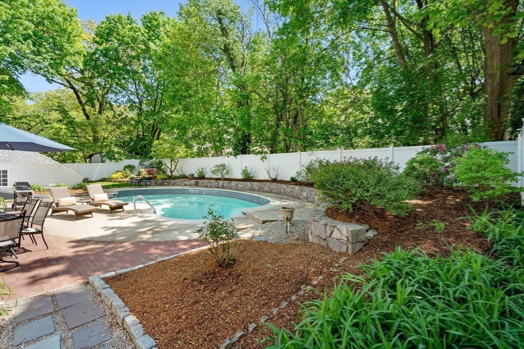 16 Bailey Lane Dedham, MA 02026 - Photo 32 of 40 a view of a backyard with table and chairs under an umbrella