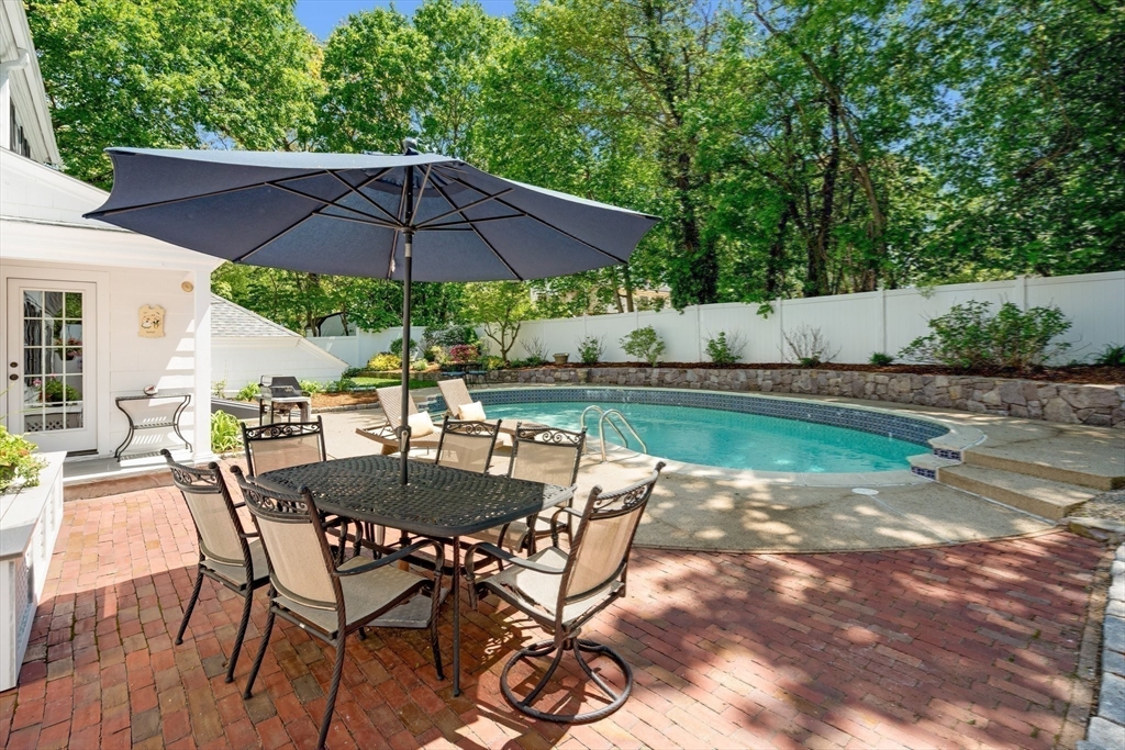 16 Bailey Lane Dedham, MA 02026 - Photo 33 of 40 a view of patio with chairs and table under an umbrella