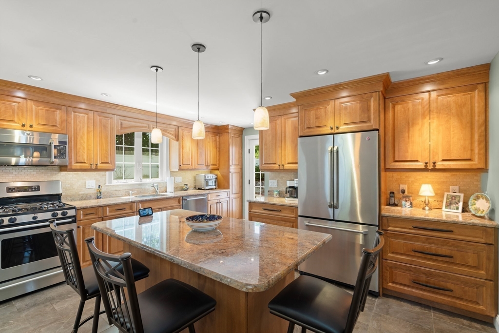 16 Bailey Lane Dedham, MA 02026 - Photo 5 of 40 a kitchen with stainless steel appliances granite countertop a stove top oven a sink island and a refrigerator