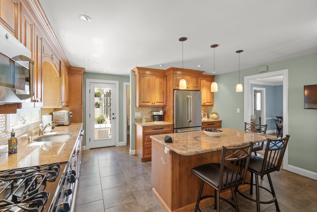 16 Bailey Lane Dedham, MA 02026 - Photo 6 of 40 a large kitchen with a table and chairs