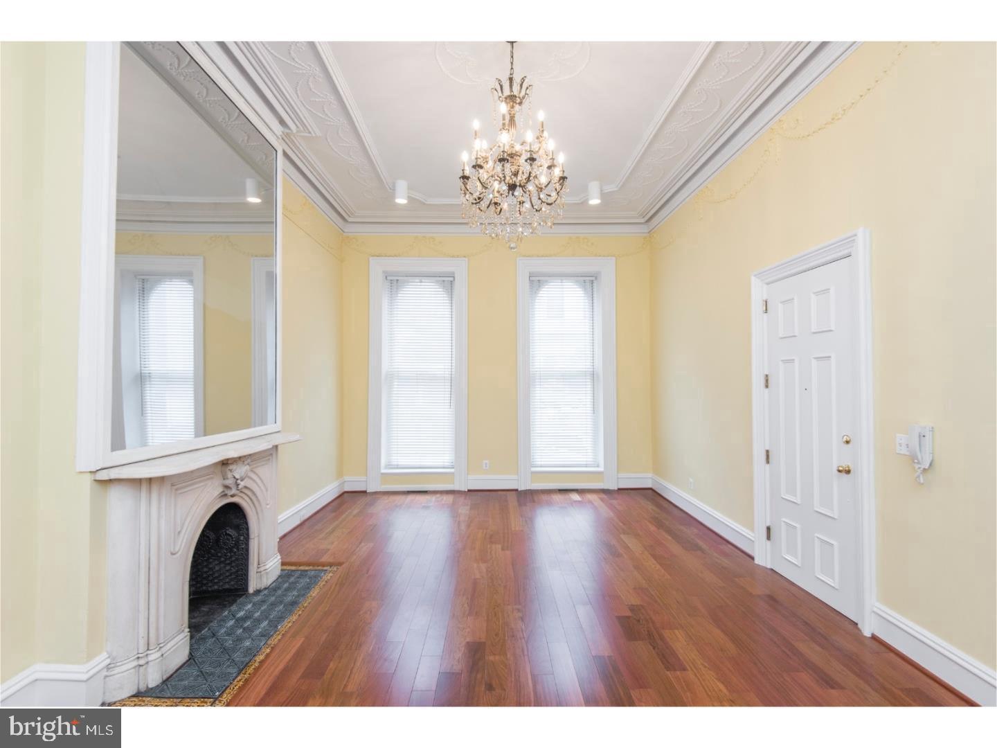 a view of livingroom with chandelier and fireplace