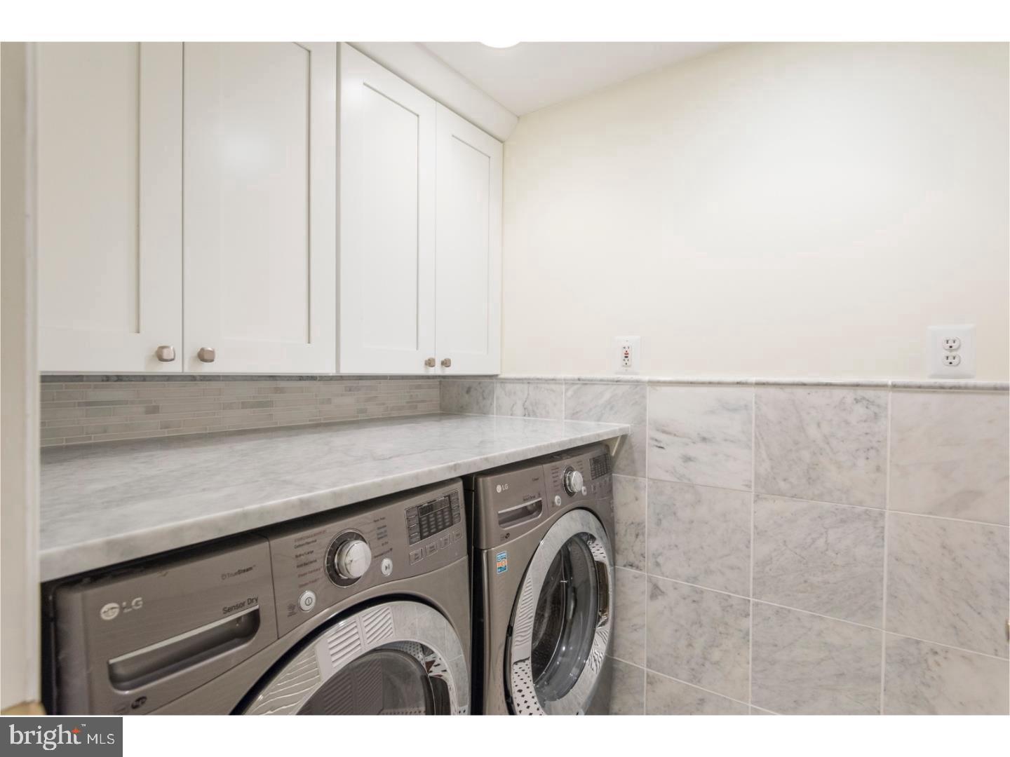 2129 Walnut Street, Unit 1 Philadelphia, PA 19103 - Photo 6 of 7 a utility room with dryer and washer