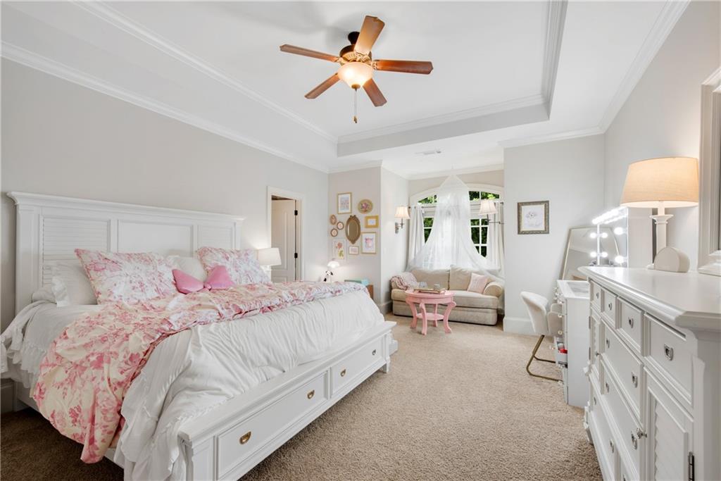 13942 Tree Loft Road Milton, GA 30004 - Photo 45 of 102 a bedroom with a bed and a chandelier