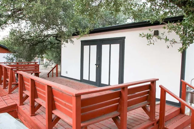 a view of a chairs and tables in the back yard