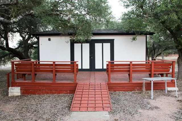 a view of a house with backyard and wooden fence