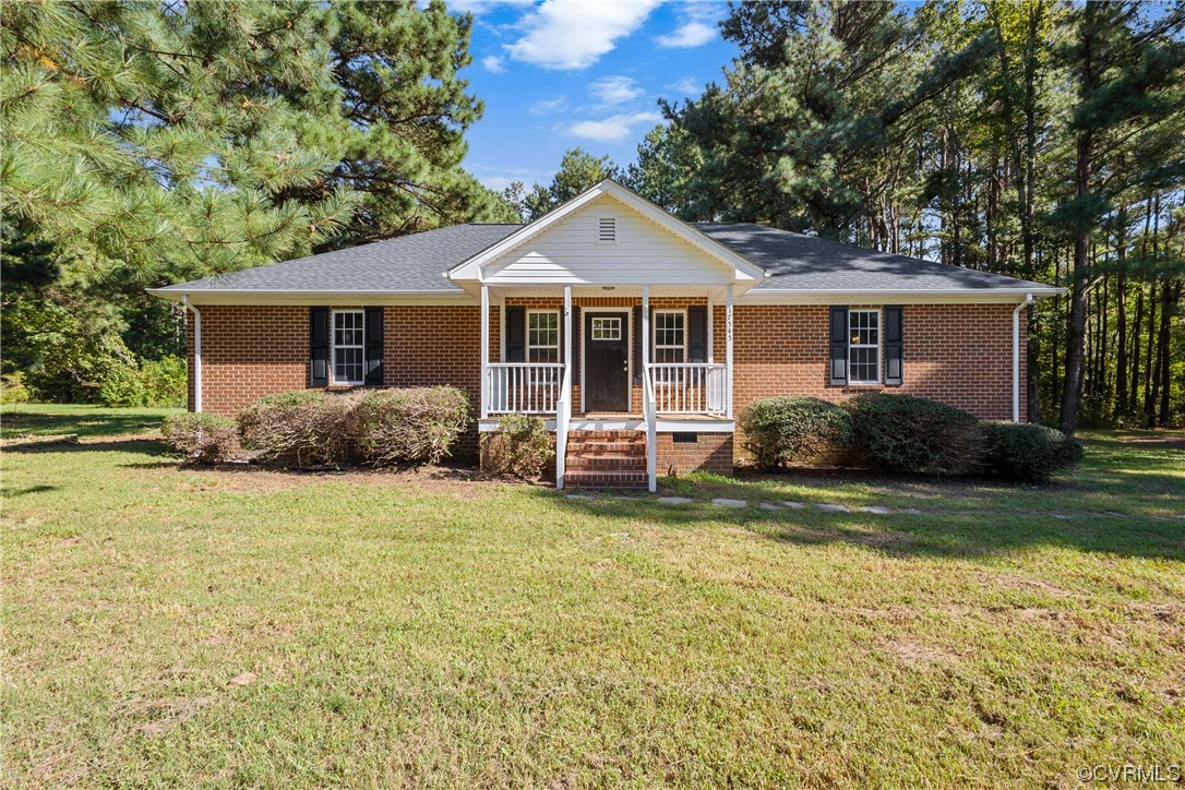 a front view of a house with a garden and trees