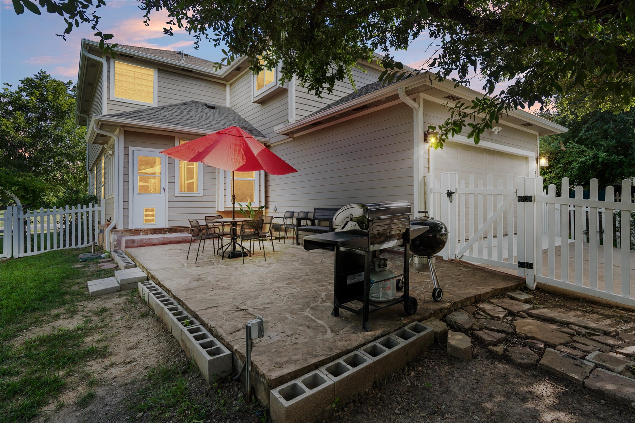 1833 Thompson Trail Round Rock, TX 78664 - Photo 34 of 40 A well-appointed concrete patio with grill and umbrella creates an inviting outdoor living space.