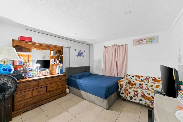 a bedroom with a bed and a dresser in it