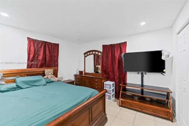a bedroom with furniture and a flat screen tv