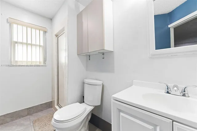 a white toilet sitting next to a bathroom sink