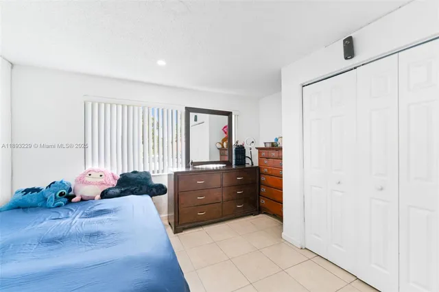 a bed room with a bed and a dresser