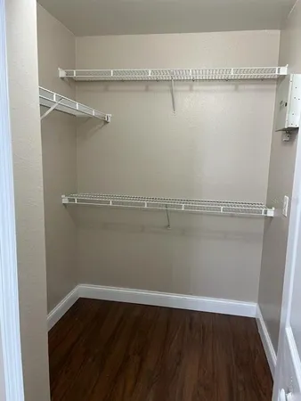 a kitchen with wooden floors and appliances