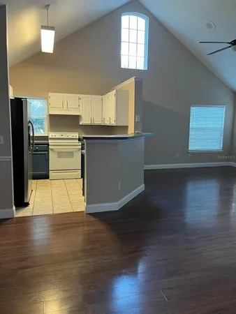 a kitchen with stainless steel appliances granite countertop a refrigerator and a stove top oven