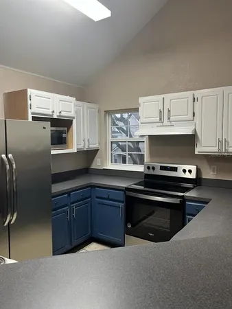 a view of a livingroom with a window and wooden floor