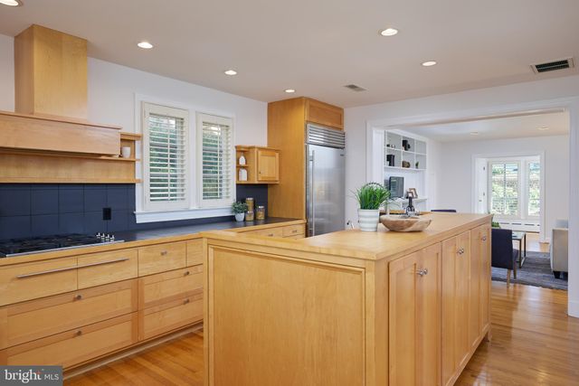 a kitchen with stainless steel appliances granite countertop a sink a stove and a refrigerator
