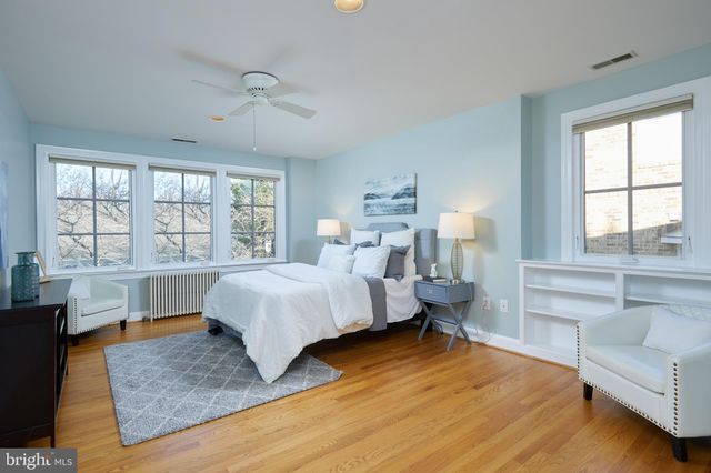 a bedroom with a large bed and a large window